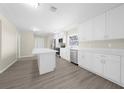 Modern kitchen with white cabinets and stainless steel appliances at 16247 Lake Johns Cir, Winter Garden, FL 34787