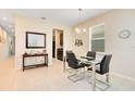 Dining room with glass table, four chairs, and an entryway at 2340 Grasmere View S Pkwy, Kissimmee, FL 34746