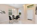 Bright dining area with glass table and four chairs at 2340 Grasmere View S Pkwy, Kissimmee, FL 34746