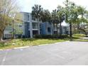 Exterior of building with palm trees, bushes, and trees on the property at 2592 Grassy Point Dr # 106, Lake Mary, FL 32746