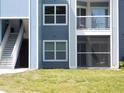 Exterior close up of light blue condo building showing stairs and balconies at 2592 Grassy Point Dr # 106, Lake Mary, FL 32746