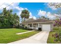 Charming ranch home with stone exterior, spacious yard, and a two-car driveway at 2842 Eastern Pkwy, Winter Park, FL 32789