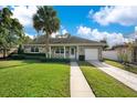 Charming ranch home with stone exterior, spacious yard, and a two-car driveway at 2842 Eastern Pkwy, Winter Park, FL 32789