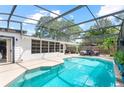 Inviting screened pool area with patio furniture and umbrella at 322 Apopka St, Winter Garden, FL 34787