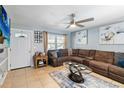 Living room featuring a brown sectional sofa and a ceiling fan at 332 Apopka Hills Cir, Apopka, FL 32703