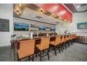 Community bar with orange chairs and large screens at 360 Belmond Dr, Debary, FL 32713