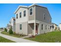 Modern two-story house with gray siding and a red door at 360 Belmond Dr, Debary, FL 32713