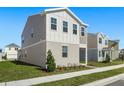 Side view of a two-story house with gray siding and landscaping at 360 Belmond Dr, Debary, FL 32713