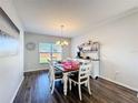 Bright dining room features a farmhouse table and storage at 5417 Calla Lily Ct, Kissimmee, FL 34758