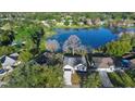 Aerial view showing a home on a lake with surrounding houses and trees at 58 Bonita Rd, Debary, FL 32713