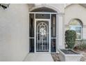 Front entrance with decorative screen door and tiled entryway at 5942 Nw 26Th Ln, Ocala, FL 34482