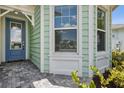 Charming front door with a blue finish and a brick walkway at 597 Lost Shaker Way, Daytona Beach, FL 32124