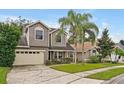 Two-story house with gray siding, beige garage door, and palm trees at 605 Brightview Dr, Lake Mary, FL 32746