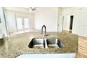 Kitchen island with granite countertop and double sink at 6356 Raleigh St # 1503, Orlando, FL 32835