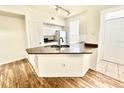 Modern kitchen with granite countertops and white cabinets at 6356 Raleigh St # 1503, Orlando, FL 32835