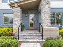 Front entrance with stone pillars and a covered porch at 6921 Arnoldson St, Orlando, FL 32827