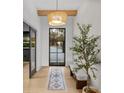 Bright entryway with a statement light fixture and stylish bench at 7 1 St Ct, Windermere, FL 34786