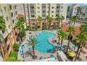 Aerial view showcasing the beautiful pool surrounded by lush landscaping and modern buildings at 7383 Universal Blvd # 207, Orlando, FL 32819
