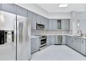 Modern kitchen with stainless steel appliances and gray cabinets at 7615 Bay Port Rd # 36, Orlando, FL 32819