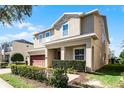 Two story house with a red door and attached garage at 7654 Wilmington Loop, Kissimmee, FL 34747