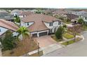 Two-story house with a three-car garage and a brick paver driveway at 8558 Morehouse Dr, Orlando, FL 32836