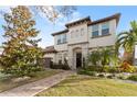 Two-story house with a three-car garage, walkway, and landscaping at 8558 Morehouse Dr, Orlando, FL 32836