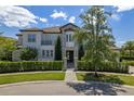 Luxury home with a manicured lawn and gated entry at 900 Jack Nicklaus Ct, Kissimmee, FL 34747