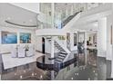 Elegant dining room with a modern circular table and staircase at 9138 Great Heron Cir, Orlando, FL 32836