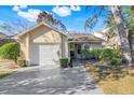 Tan house with white garage door and manicured lawn at 1163 Saddleback Ridge Rd, Apopka, FL 32703