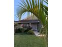 House exterior with walkway, landscaping, and palm tree at 156 Pine Cone Dr, Davenport, FL 33897