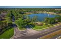 Community entrance with lake, fountain, and lush landscaping at 169 Magneta Loop, Auburndale, FL 33823
