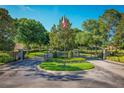 Gated community entrance with landscaping and flag at 169 Magneta Loop, Auburndale, FL 33823