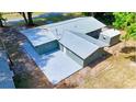 Aerial view of a house with metal roof and detached shed at 1778 Cr 426, Lake Panasoffkee, FL 33538