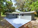 Rear view showing newly poured concrete patio at 1778 Cr 426, Lake Panasoffkee, FL 33538