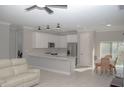 Open concept kitchen with stainless steel appliances and an island at 227 W 4Th St, Chuluota, FL 32766