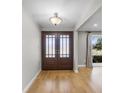 Bright entryway with hardwood floors and double doors leading into the home at 230 W Spring Lake Dr, Altamonte Springs, FL 32714