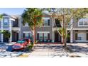 Front view of two-story townhome with gray siding at 2394 Caravelle Cir, Kissimmee, FL 34746