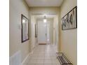 Bright and spacious entryway with tile flooring and a coat rack at 334 Orange Cosmos Blvd, Davenport, FL 33837