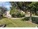 Landscaped backyard with lush greenery and a patio area at 3518 Kilmarnock Dr, Apopka, FL 32712