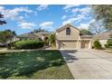 Two-story house with a three-car garage and well-maintained landscaping at 3518 Kilmarnock Dr, Apopka, FL 32712