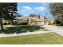 Spacious two-story house with a three-car garage, neat lawn, and sidewalk at 3518 Kilmarnock Dr, Apopka, FL 32712