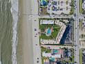 Aerial view showing building, pool, and beach access at 3663 S Atlantic Ave # 11D, New Smyrna Beach, FL 32169