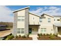 Modern townhome with green door and stone accents at 4355 Scene Ln, Kissimmee, FL 34746