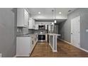 Renovated kitchen with white shaker cabinets and stainless steel appliances at 5526 Lily Rd, Lakeland, FL 33811