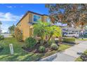 Two-story house with palm trees, manicured landscaping, and a view of the neighborhood at 7343 Derexa Dr, Windermere, FL 34786