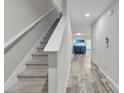 Entryway with carpeted stairs and wood-look tile flooring at 12067 White Wave Pt, Orlando, FL 32828