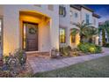 Elegant entryway with a dark wood door and a stone walkway at 124 Adler Pt, Oviedo, FL 32765