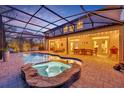 Inviting pool and spa area with a screened enclosure and patio furniture at 124 Adler Pt, Oviedo, FL 32765