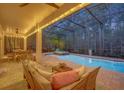 Relaxing screened patio with a pool, spa, and outdoor seating at 124 Adler Pt, Oviedo, FL 32765