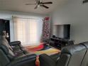 Living room with TV, couches, and colorful rug at 155 N Pearl Lake Cswy # 200, Altamonte Springs, FL 32714